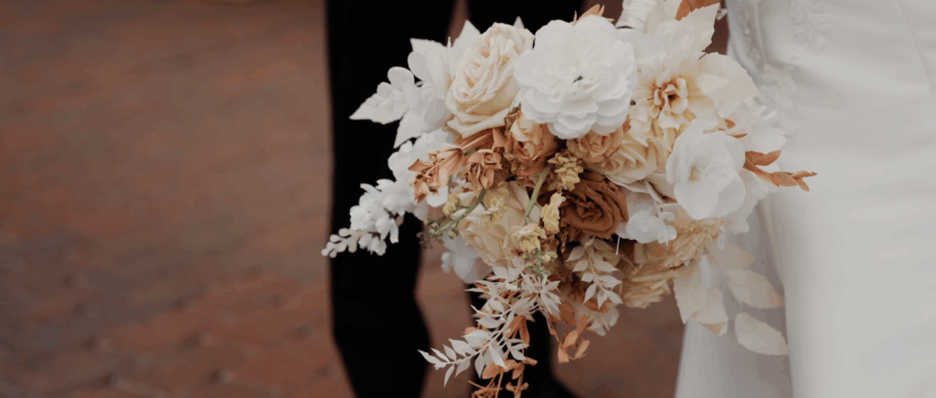 Bride holds her bouquet of flowers from her wedding for a tight shot to capture the details.