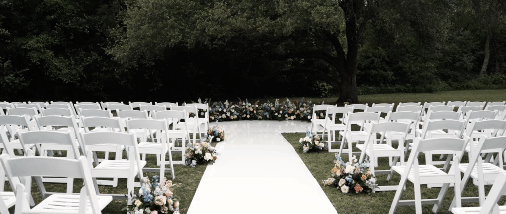 Chairs set up at a wedding venue in Houston, TX with flowers brightening up the space.
