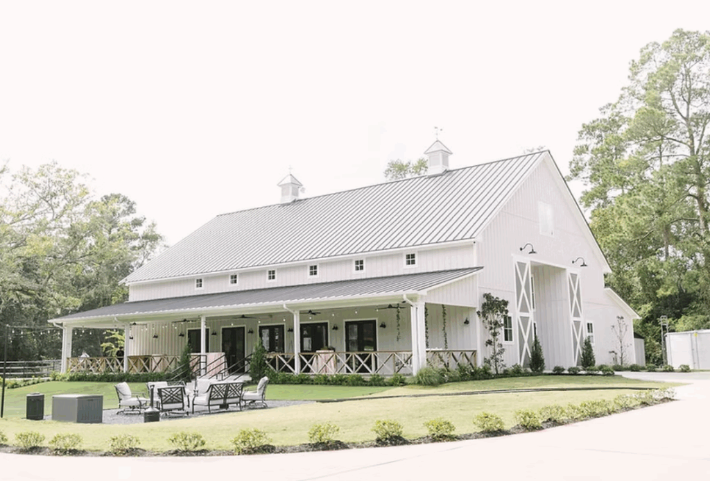 Addison Woods venue near Houston, Texas — a modern farmhouse-style building surrounded by oak trees and landscaped gardens.