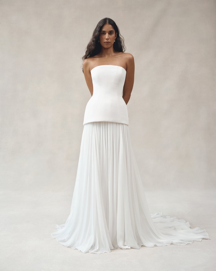 Bride in the Alice gown by Alexandra Grecco, an ivory silk wedding dress with a fitted bodice, strapless and rounded neckline, and flowing A-line skirt.