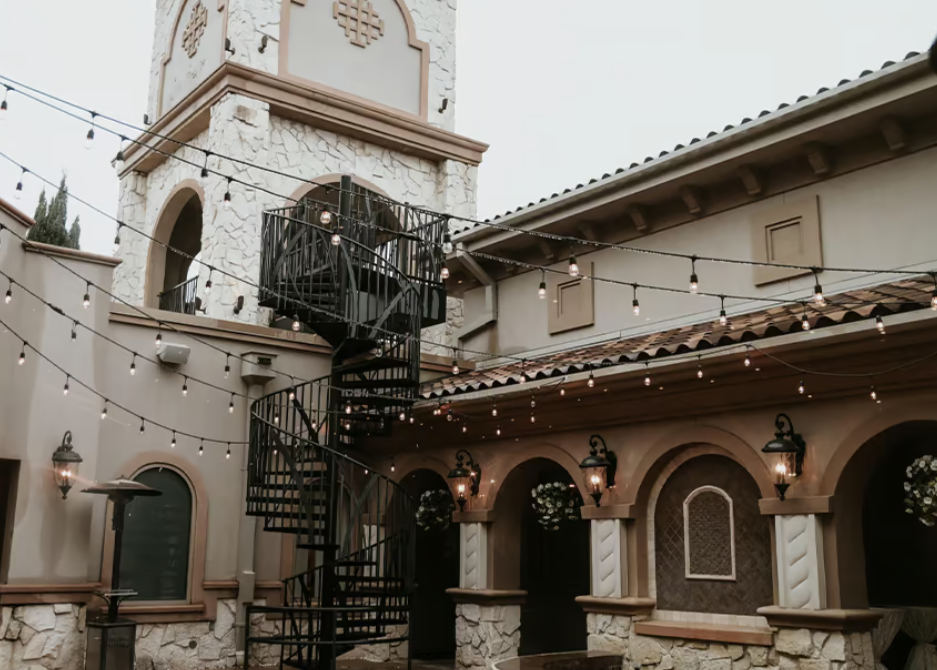 Exterior view of Aristide wedding venue in Texas, showcasing a modern elegant building with large windows, stylish architecture, and landscaped grounds.