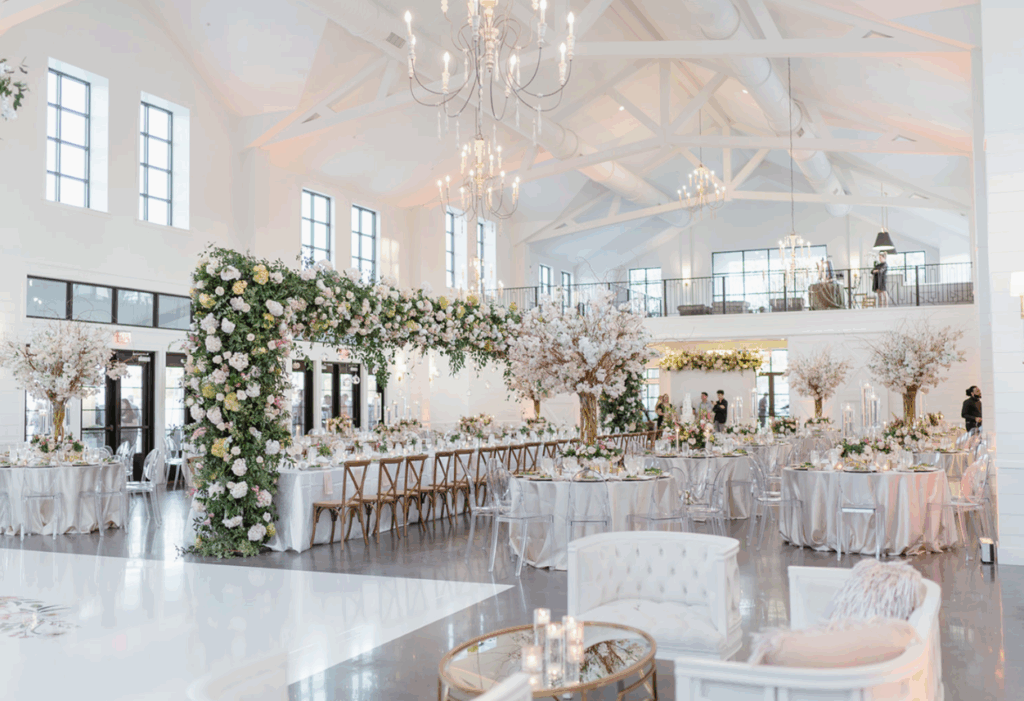 Bright, elegant interior of Boxwood Manor near Houston, featuring white walls, tall ceilings, and natural light streaming through expansive windows.