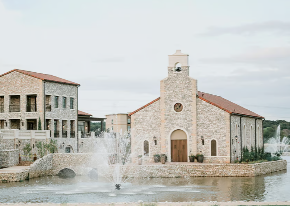 Exterior view of The Chapel at Palacios wedding venue, featuring a charming chapel building with a picturesque entrance and surrounding greenery.