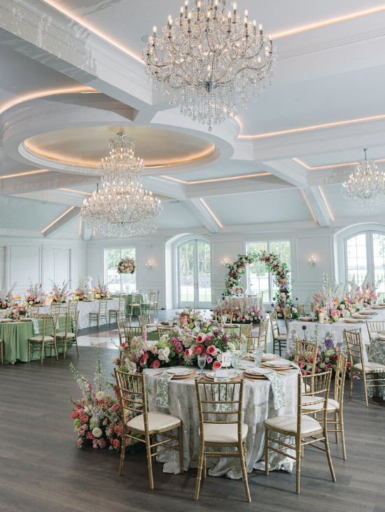 Interior of Hillside Estates wedding venue with tables and chairs arranged for a reception, featuring elegant décor and ambient lighting.