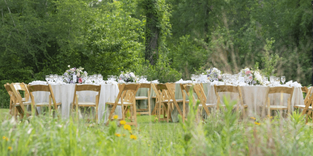 Table set ups at the Houston Arboretum and Nature Center with walking trails surrounded by lush trees and native plants.