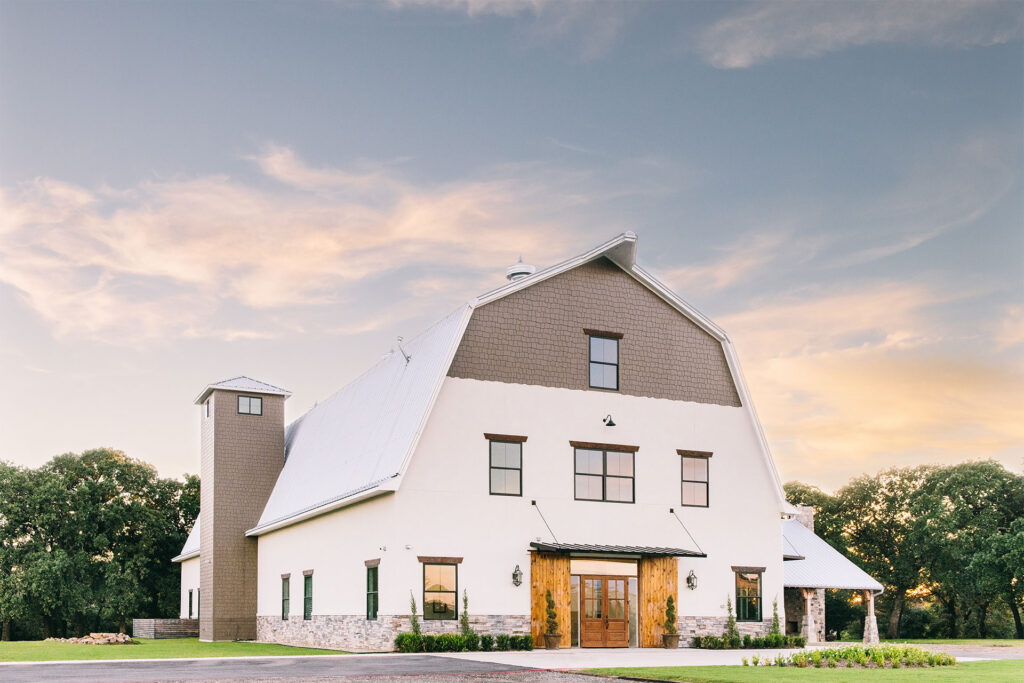 Exterior view of Oak & Ivy wedding venue in Texas, featuring a modern rustic design with lush greenery and outdoor event spaces.