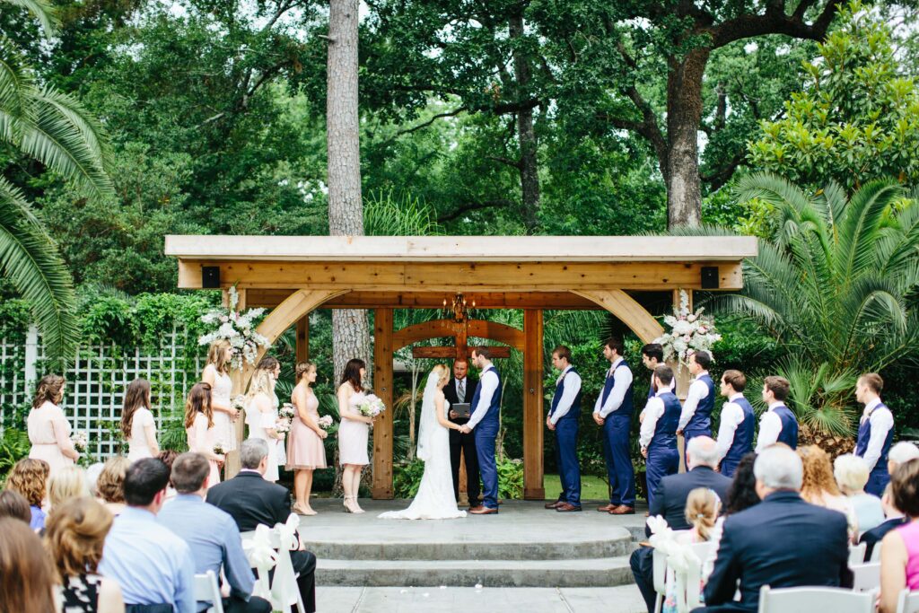 Wedding ceremony at Shirley Acres in Houston, Texas, featuring a beautifully decorated outdoor space with guests seated and the couple at the altar.