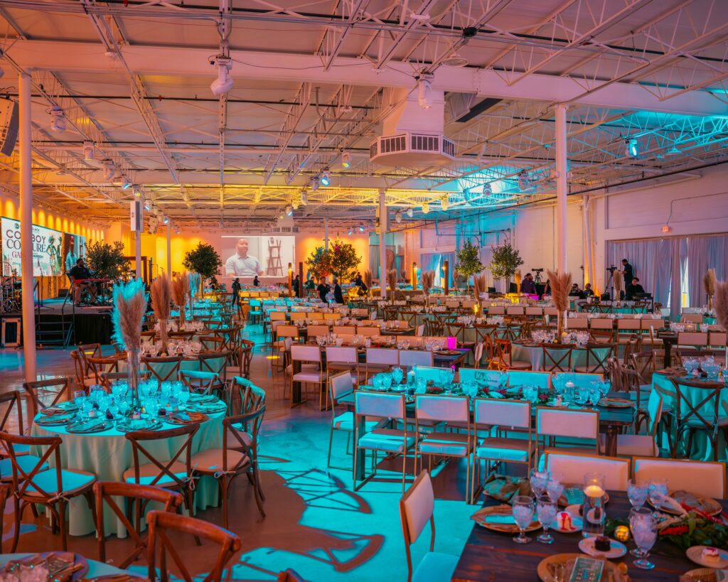 Interior of The Astoria wedding venue in Dallas, Texas, showcasing elegant chandeliers, draped ceilings, and tables set for a formal reception.