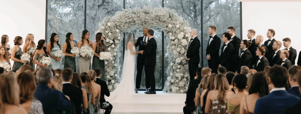 Bride and groom exchanging vows at Union House in Dallas, Texas, surrounded by guests in a modern, light-filled wedding venue.