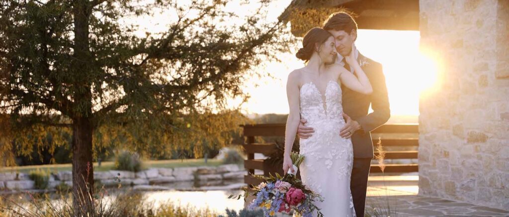 The bride and groom in this Texas setting embrace after their wedding during golden hour.